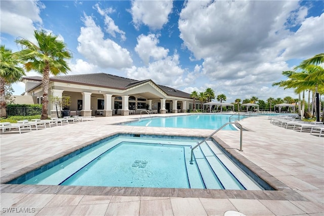 view of swimming pool with a patio area and a community hot tub