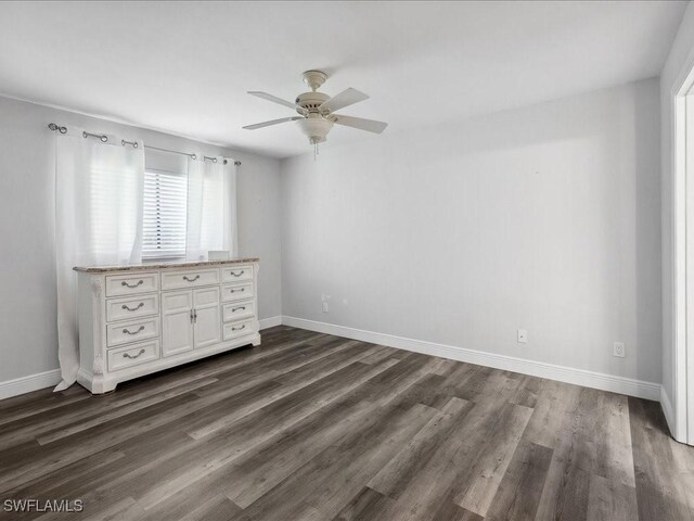 unfurnished bedroom featuring dark hardwood / wood-style flooring and ceiling fan