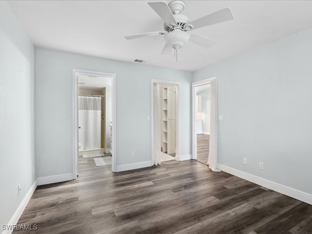 unfurnished bedroom featuring a closet, ceiling fan, hardwood / wood-style floors, and ensuite bath