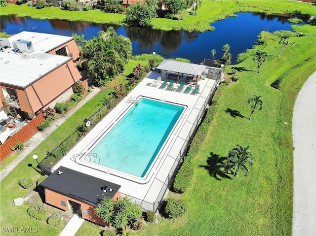 drone / aerial view of a nearby body of water and a pool area