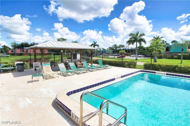 community pool featuring a gazebo, fence, and a patio area