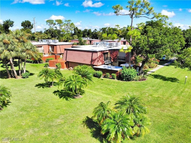 view of grassy yard with a deck