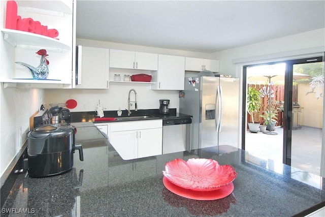 kitchen with open shelves, stainless steel appliances, a sink, and white cabinetry