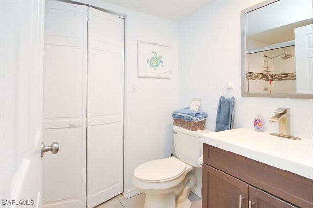 full bathroom with toilet, vanity, and tile patterned floors