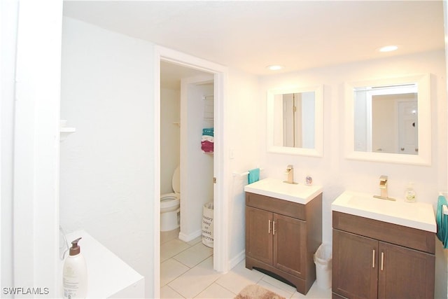 full bath with tile patterned floors and two vanities