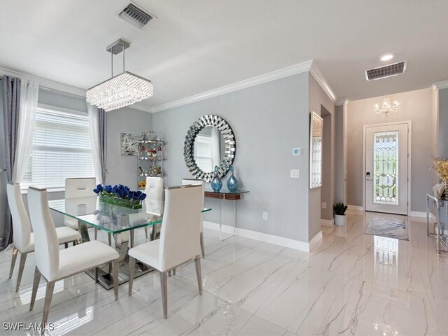 dining room featuring crown molding, a healthy amount of sunlight, and an inviting chandelier