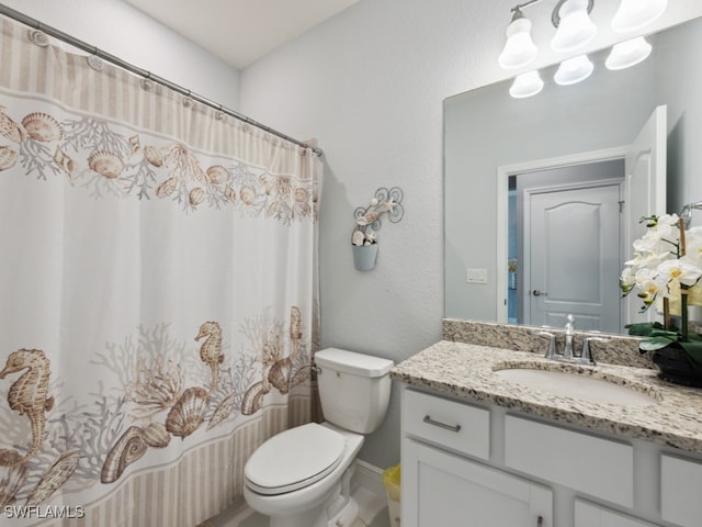 bathroom featuring vanity, curtained shower, and toilet