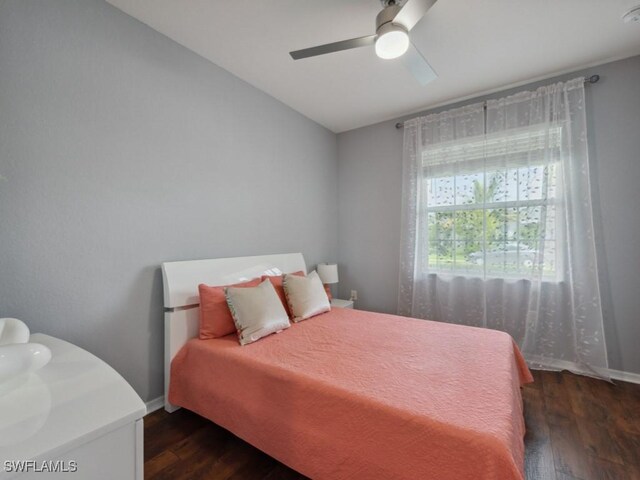 bedroom with ceiling fan and dark hardwood / wood-style flooring