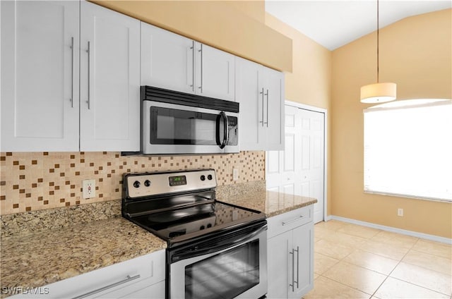 kitchen featuring vaulted ceiling, decorative light fixtures, tasteful backsplash, white cabinetry, and stainless steel appliances