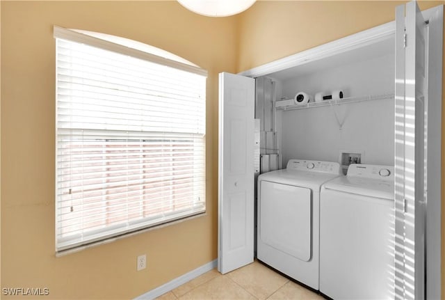 washroom with washer and dryer and light tile patterned floors