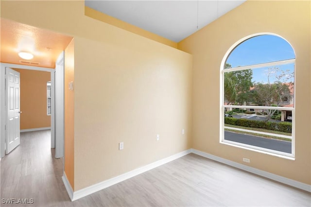 spare room featuring light wood-type flooring