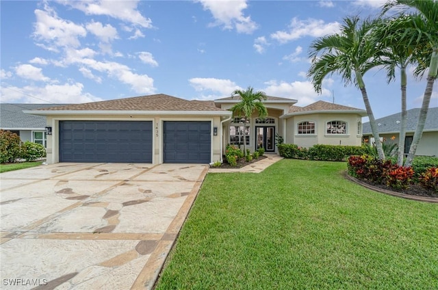 view of front of home with a garage, driveway, french doors, stucco siding, and a front lawn