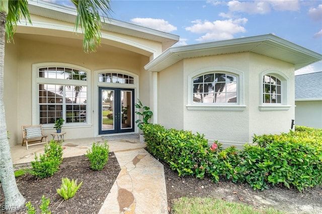 doorway to property with french doors and stucco siding