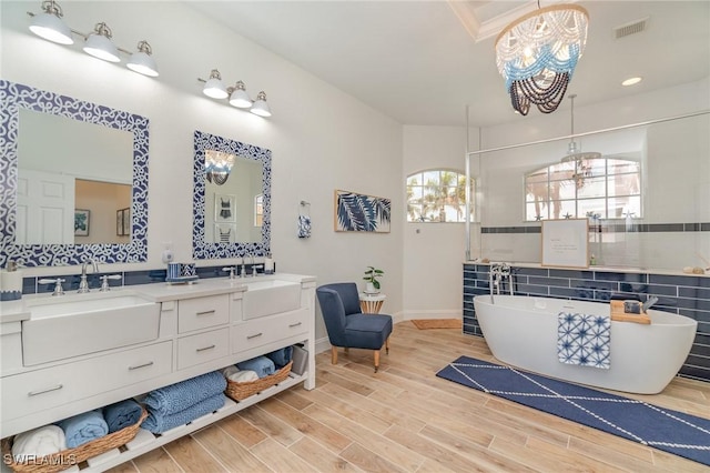 bathroom featuring a chandelier, a sink, and visible vents