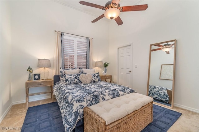 carpeted bedroom with a ceiling fan and baseboards