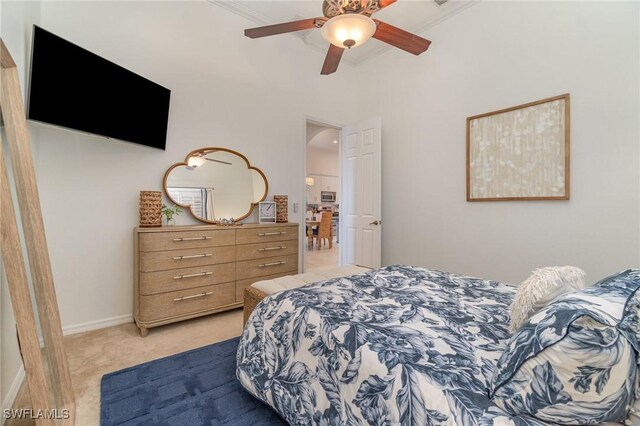 bedroom featuring baseboards, a ceiling fan, and light colored carpet