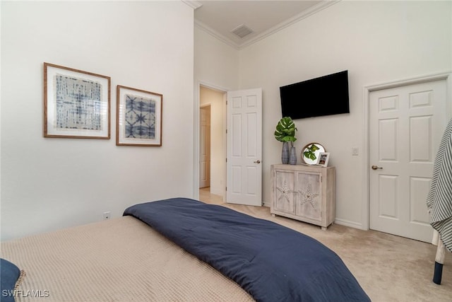 bedroom with ornamental molding, light carpet, visible vents, and baseboards