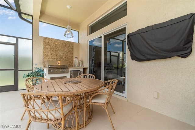 view of patio with exterior kitchen, outdoor dining area, and grilling area