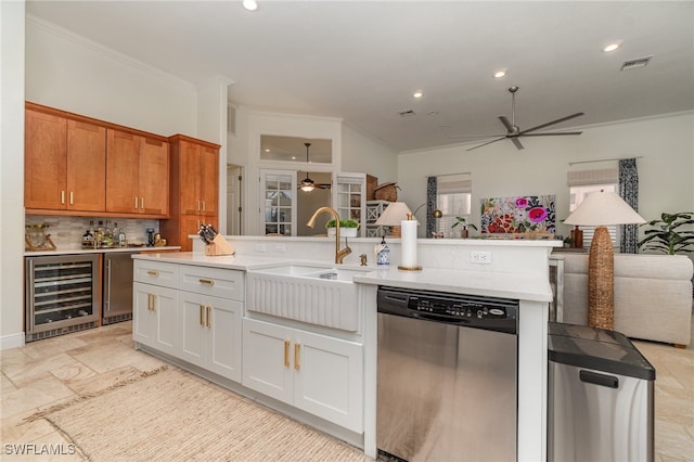 kitchen with open floor plan, stainless steel dishwasher, wine cooler, and a sink