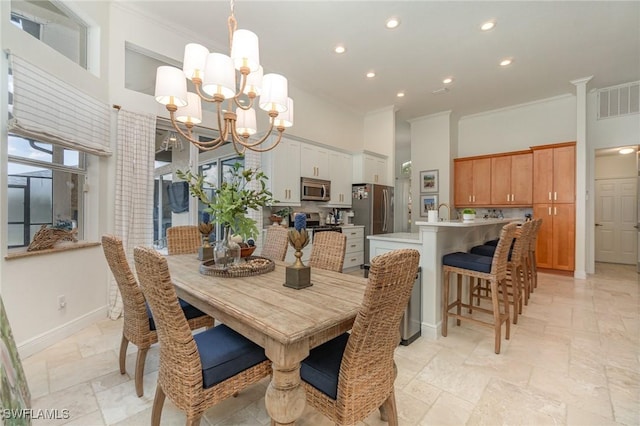 dining space with baseboards, a high ceiling, visible vents, and crown molding