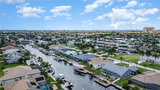 birds eye view of property with a water view and a residential view