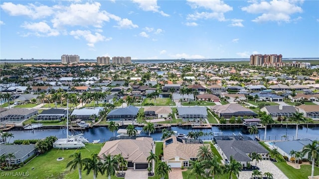 birds eye view of property with a residential view and a water view