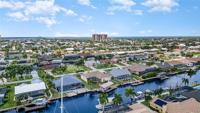 birds eye view of property with a water view and a residential view