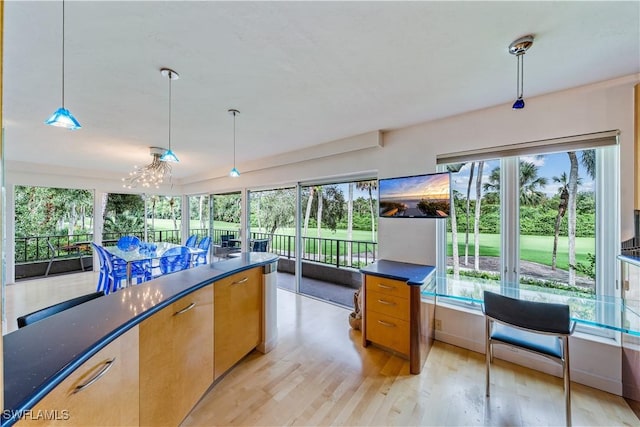 kitchen featuring an inviting chandelier, light hardwood / wood-style flooring, and decorative light fixtures