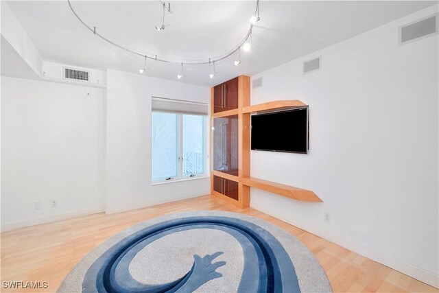 interior space featuring track lighting and light wood-type flooring