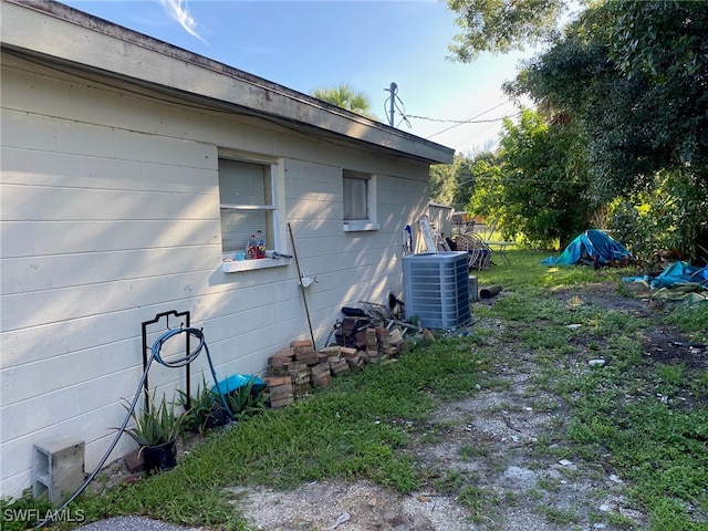 view of side of home with central air condition unit