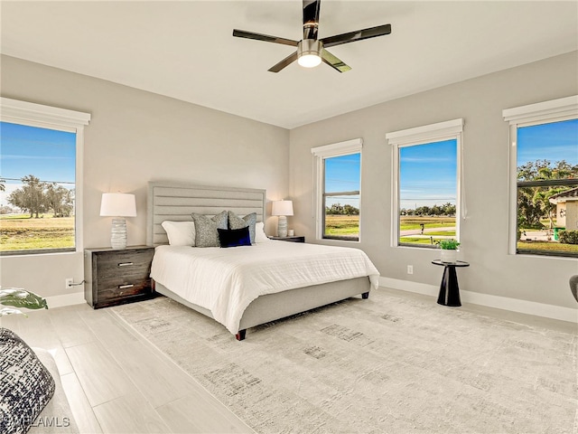 bedroom featuring ceiling fan and multiple windows