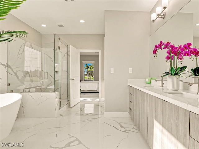 bathroom with shower with separate bathtub and vanity