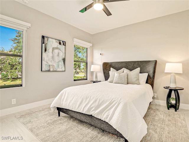 bedroom with wood-type flooring and ceiling fan