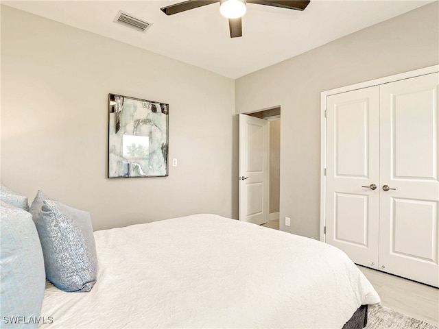 bedroom with ceiling fan, hardwood / wood-style flooring, and a closet