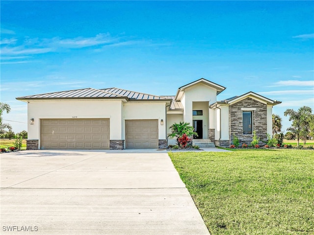 view of front of home featuring a front yard and a garage