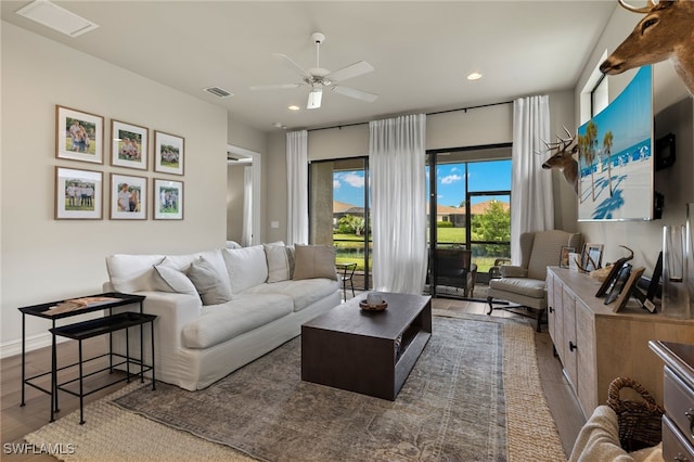 living room with ceiling fan and wood-type flooring