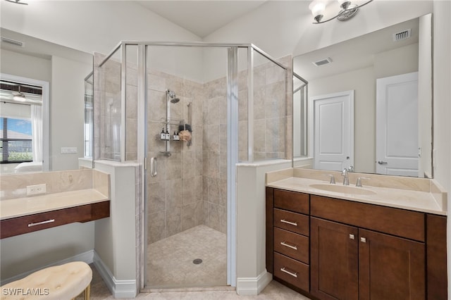 bathroom with tile patterned floors, a shower with door, and vanity