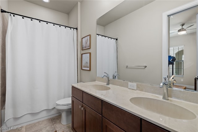 full bathroom featuring vanity, tile patterned floors, ceiling fan, toilet, and shower / bath combo with shower curtain