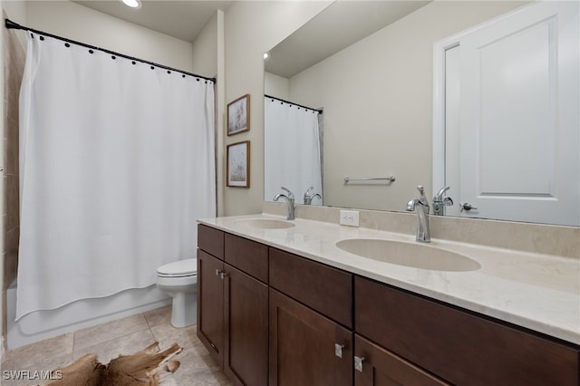 bathroom featuring double vanity, shower / bath combination with curtain, tile patterned flooring, and a sink