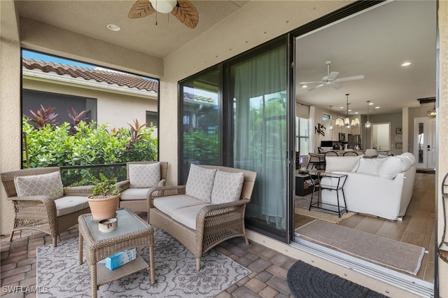 exterior space with outdoor lounge area and ceiling fan