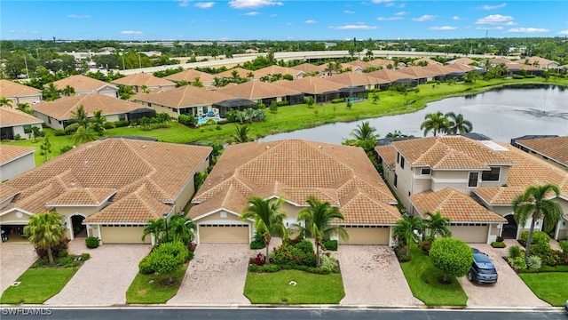 birds eye view of property with a residential view and a water view