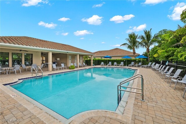 pool featuring a ceiling fan, a patio, and fence