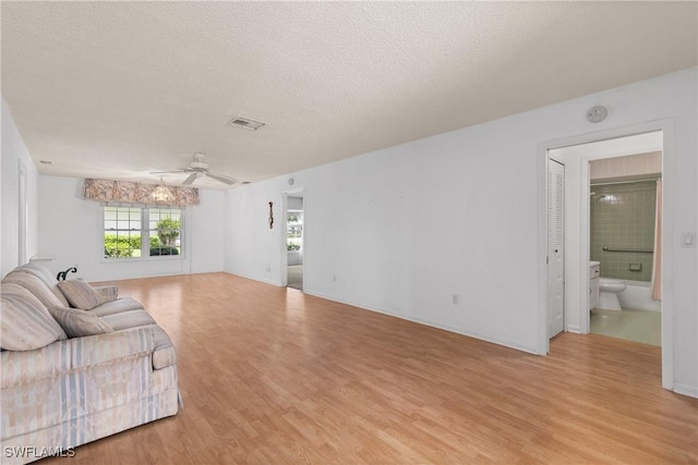 7076 E Brandywine Cir, Fort Myers, FL 33919 - living room with light wood-style flooring, a textured ceiling, and a ceiling fan