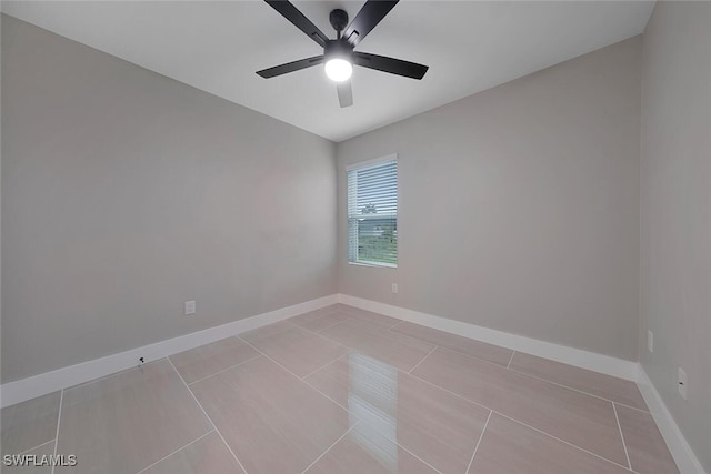 empty room featuring ceiling fan and light tile patterned floors