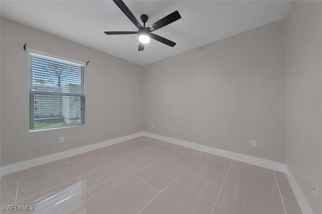 unfurnished room with ceiling fan and light tile patterned flooring