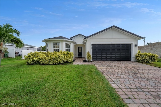 ranch-style house featuring a front yard and a garage