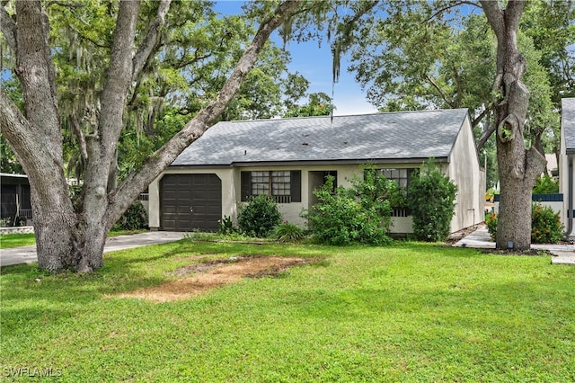 ranch-style house featuring a garage and a front yard