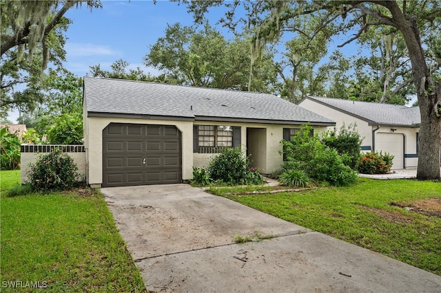 single story home featuring a garage and a front yard