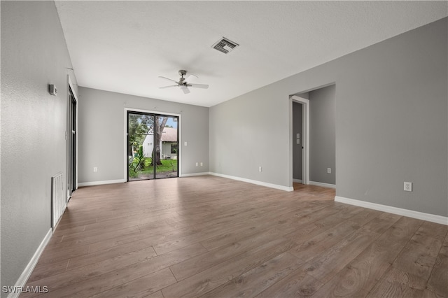 unfurnished room featuring ceiling fan and hardwood / wood-style floors