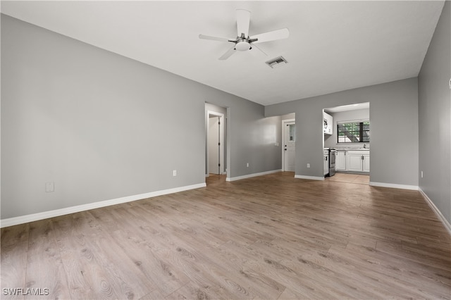 unfurnished living room with ceiling fan and light hardwood / wood-style flooring